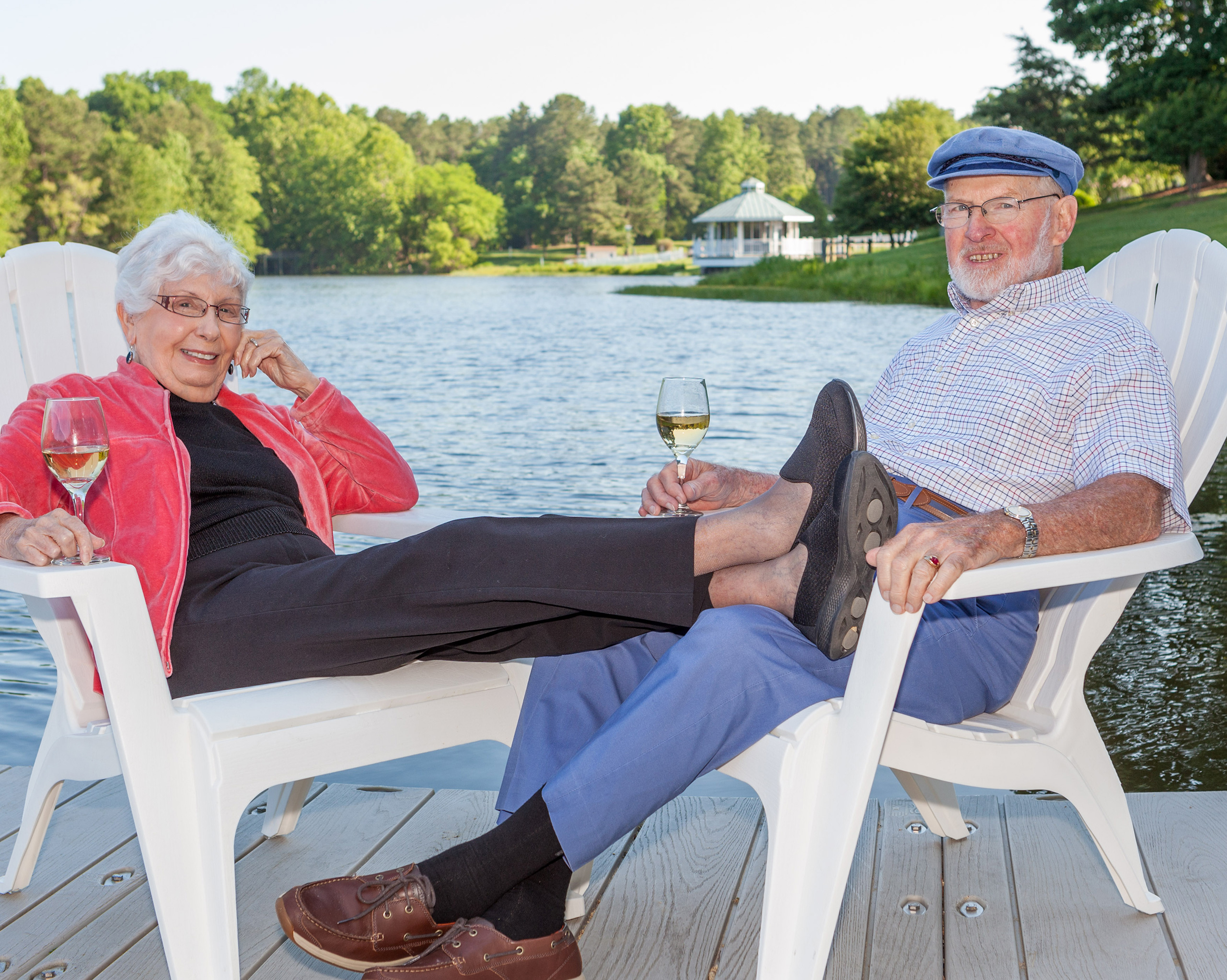 Judge Hess and his wife enjoy some wine while sitting on the dock at the lake